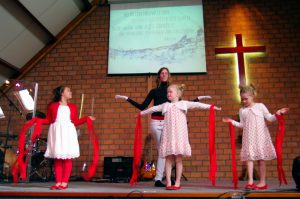 Schinnen, the Netherlands - April 20, 2014: Children are dancing on Easter day in the local Church. As you can see they are very concentrated in this Service of Celebration.